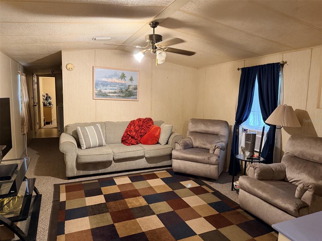A living room features a sofa, two recliners, a patterned area rug, and a ceiling fan — 355 NE 436 AVENUE, OLD TOWN, FL