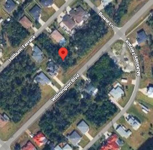 This is an aerial map view showing a vacant lot marked with a red pin — 9196 WILLMINGTON BOULEVARD, ENGLEWOOD, FL