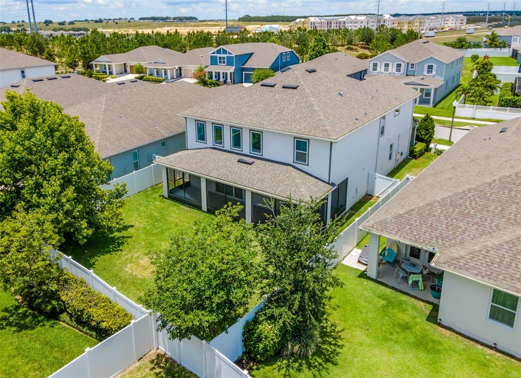 An aerial view of a two-story house with a screened-in patio and fenced backyard — 15372 SUGAR CITRUS DRIVE, WINTER GARDEN, FL