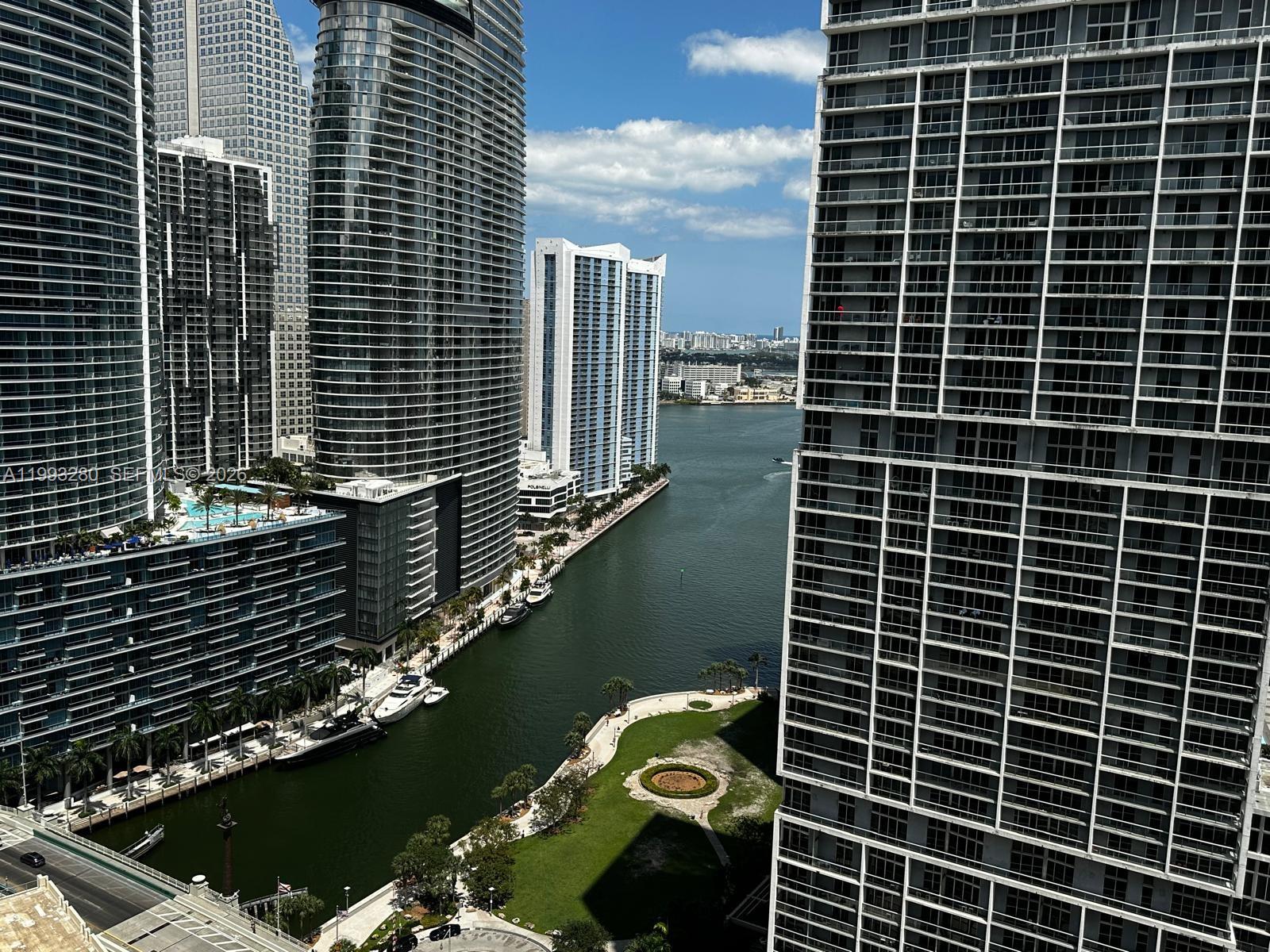 High-angle view of a Miami waterway surrounded by modern high-rise residential towers and parks — 500 Brickell Ave # 3307, Miami FL 33131, MIAMI, FL
