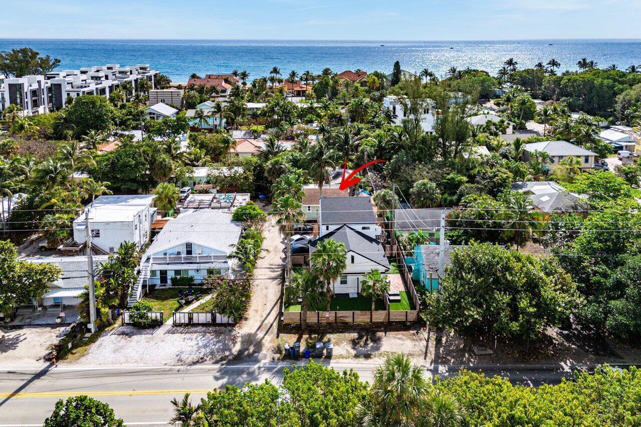 An aerial view of a coastal neighborhood featuring houses, palm trees, and a nearby beach — 4603 N Ocean Boulevard, Boynton Beach FL 33435, BOYNTON BEACH, FL