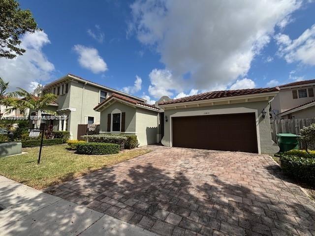 A two-story house with a paved driveway and a two-car garage under a blue sky — 15415 SW 175th St, Miami FL 33187, MIAMI, FL