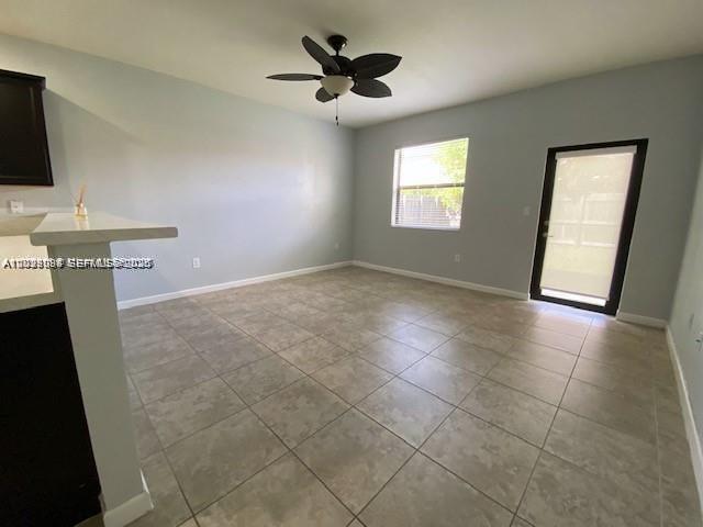 A room with light-colored tile flooring, a ceiling fan, a window, and a glass door — 15415 SW 175th St, Miami FL 33187, MIAMI, FL