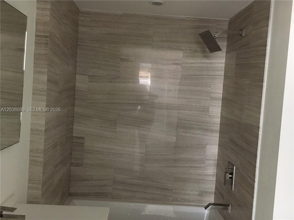 A bedroom features a bed, a desk with a chair, and a balcony with city views — 1300 Brickell Bay Dr # 710, Miami FL 33131, MIAMI, FL