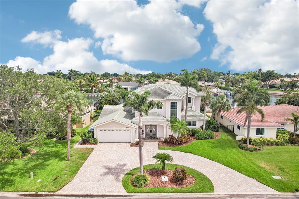 An aerial view of a two-story house with a paved driveway and palm trees — 2032 MASSACHUSETTS AVENUE NE, ST PETERSBURG, FL