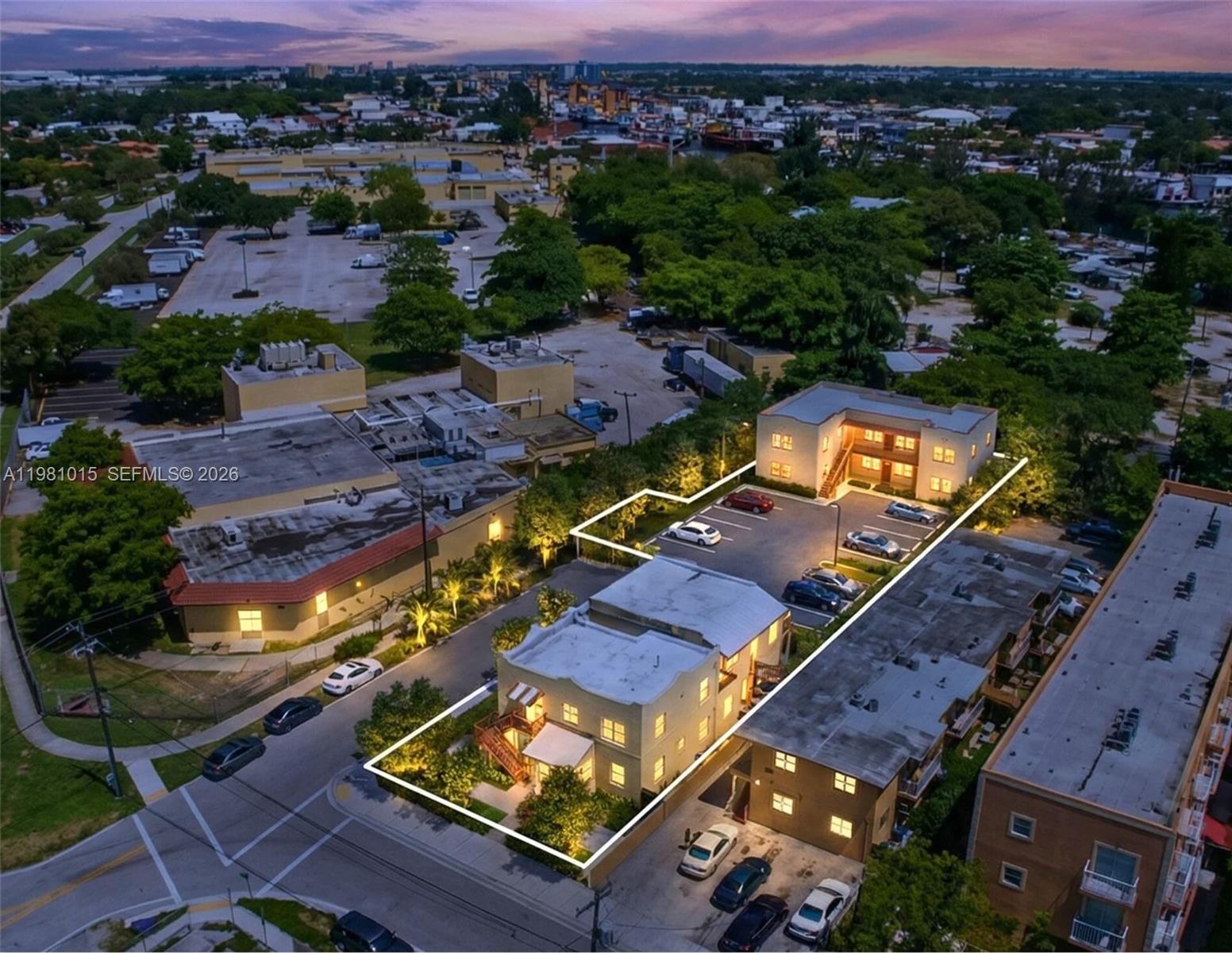 An aerial view shows two multi-story apartment buildings with parking lots at dusk — 2765 NW 17th Ter, Miami FL 33125, MIAMI, FL