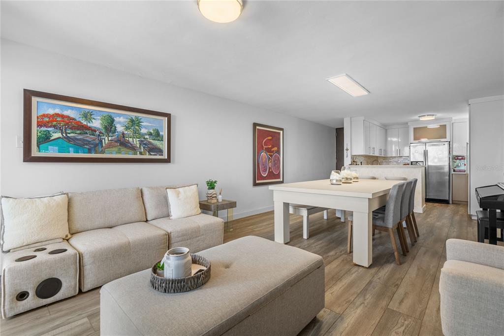 A living and dining area with light wood floors, a beige sofa, and white furniture — Castillos Del Mar LAURO PIÑERO UNIT KC-PH, CEIBA, PR