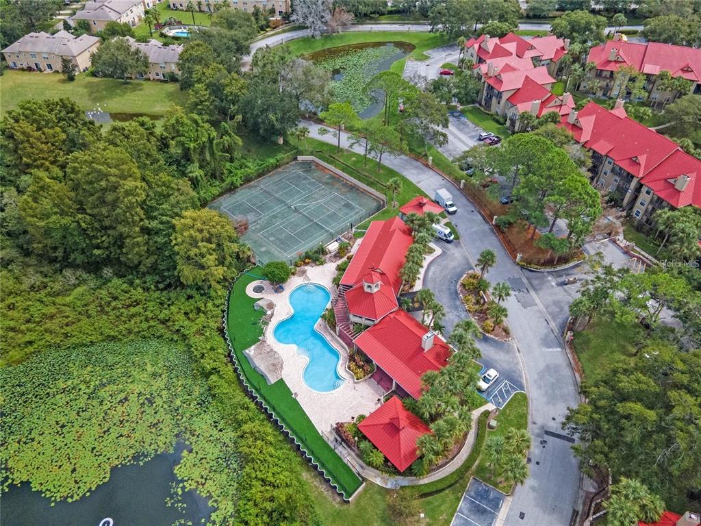 An aerial view shows a community pool, tennis court, and clubhouse with red metal roofs — 236 AFTON SQUARE UNIT 305, ALTAMONTE SPRINGS, FL
