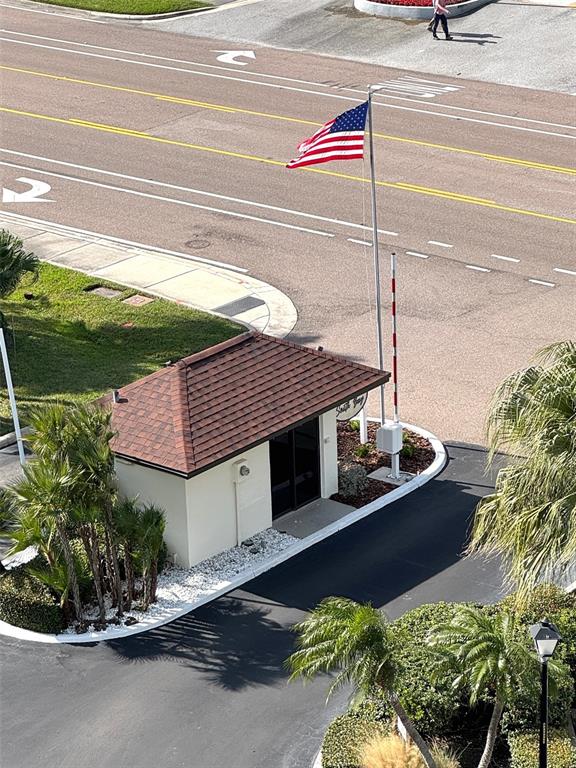 An aerial view shows a small guardhouse with a brown roof and an American flag — 1501 GULF BOULEVARD UNIT 603, CLEARWATER BEACH, FL