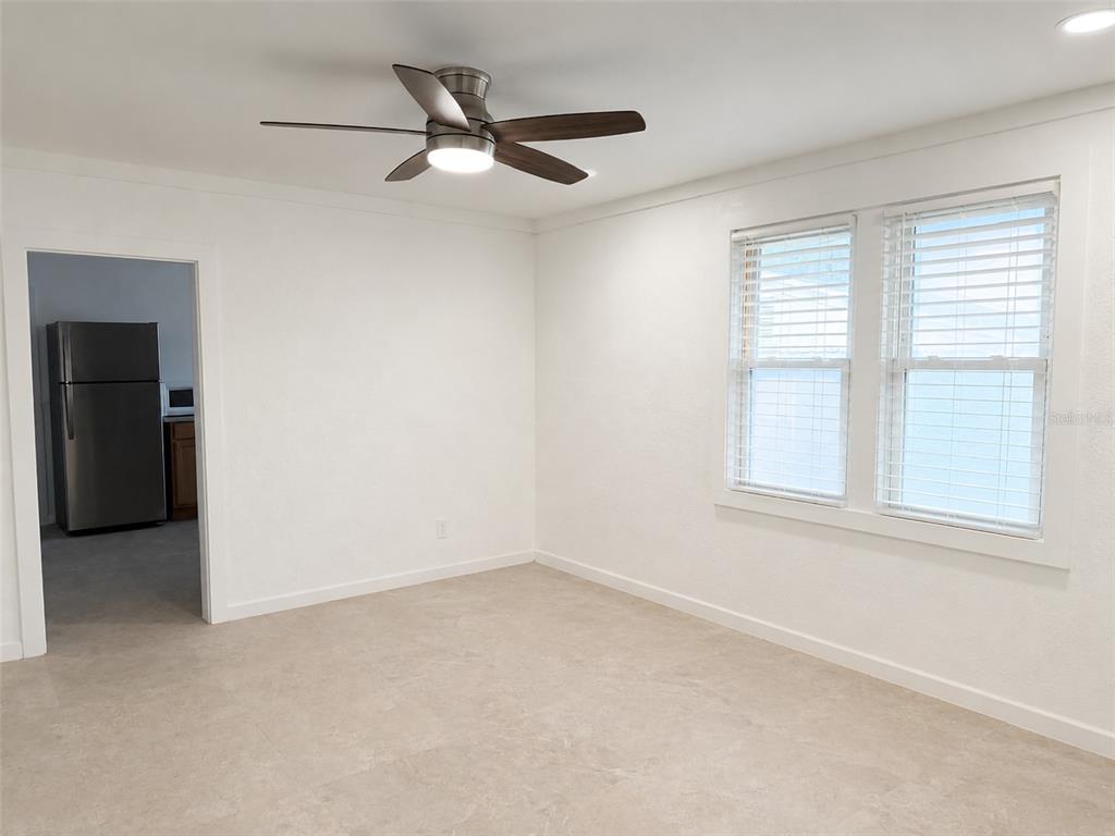 A room with white walls, tile flooring, a ceiling fan, and two windows with blinds — 111 PAGE STREET, ORLANDO, FL