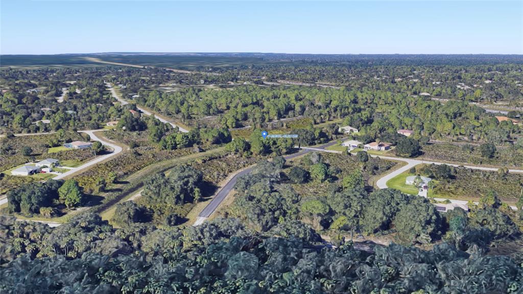An aerial view shows a vacant, wooded residential lot surrounded by scattered houses and roads — LARATONDA ROAD Lot 27, NORTH PORT, FL
