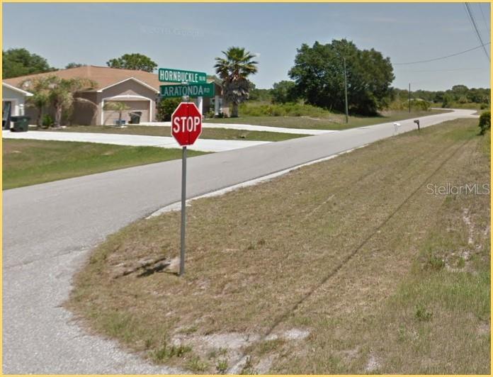 A street corner features a stop sign and street signs for Hornbuckle and Laratonda roads — LARATONDA ROAD Lot 27, NORTH PORT, FL