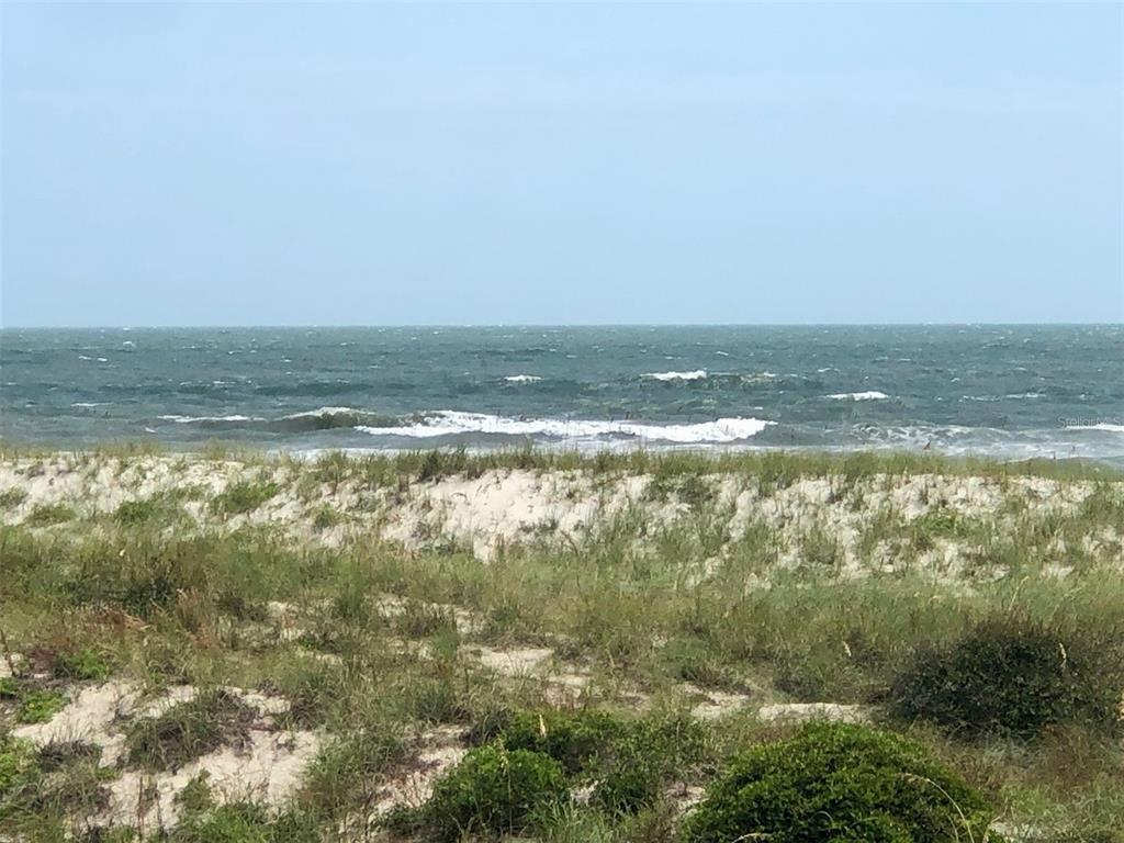 A view of the ocean and waves from behind a grassy sand dune — 5242 SEA CHASE DRIVE DRIVE UNIT 1, FERNANDINA BEACH, FL