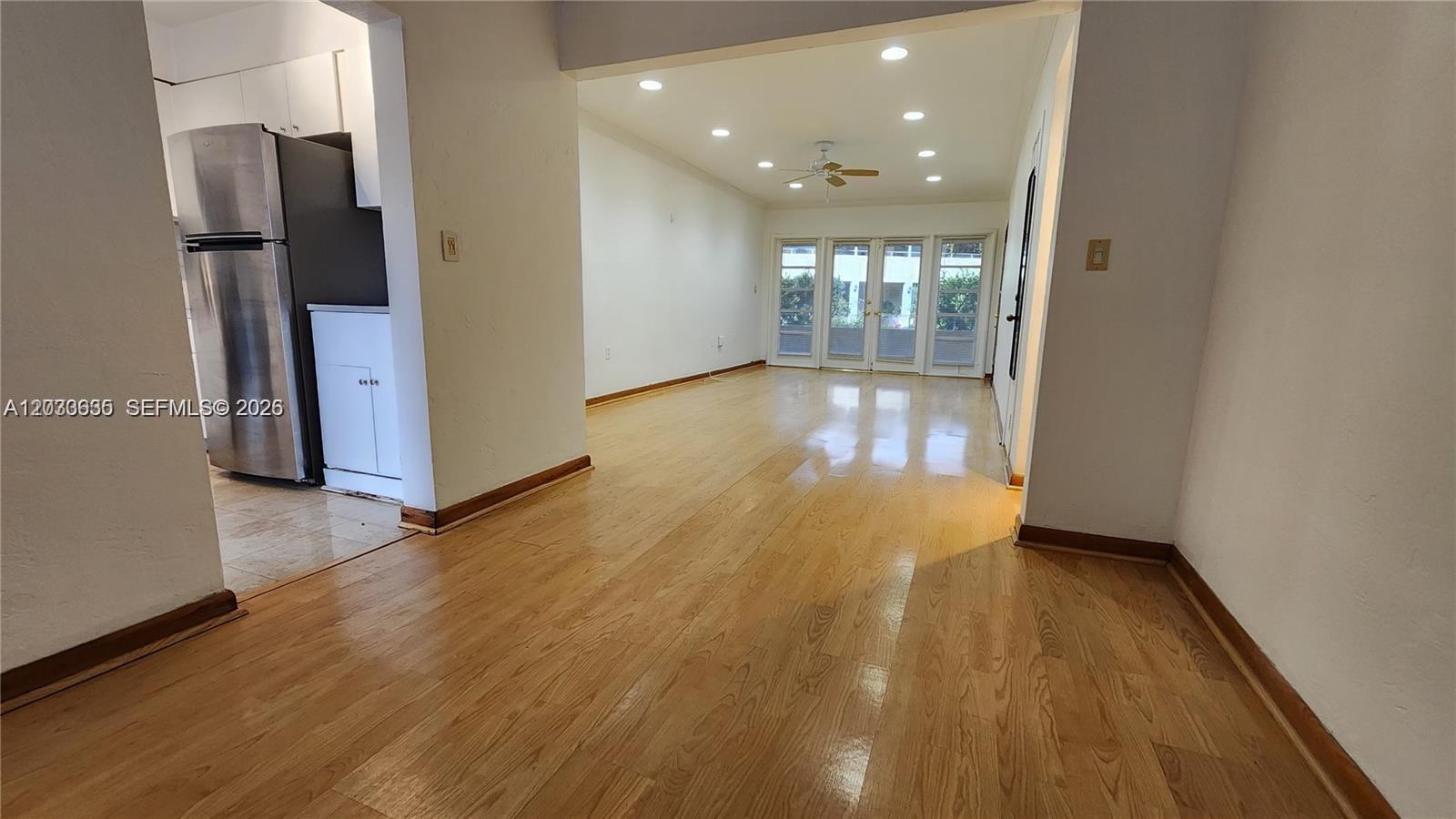 A living room with hardwood floors, recessed lighting, and a view of glass doors — 20 Park Dr # 4A, Bal Harbour FL 33154, BAL HARBOUR, FL