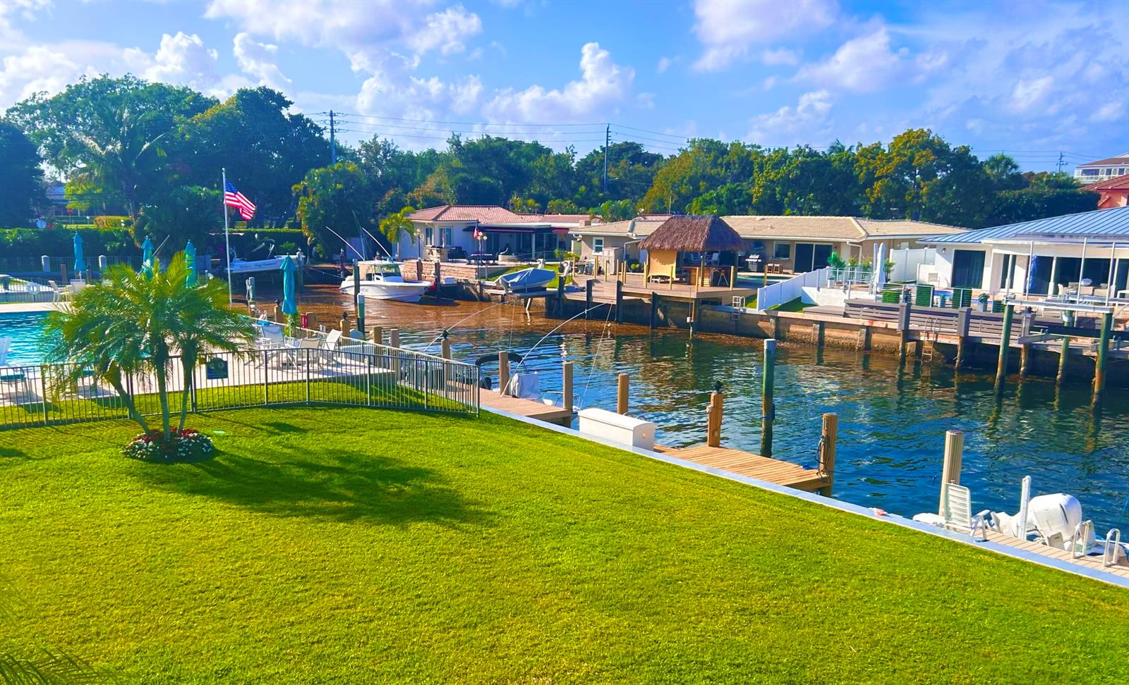 A grassy lawn overlooks a canal with private boat docks and waterfront homes — 701 NE Harbour Terrace # 2140, Boca Raton FL 33431, BOCA RATON, FL