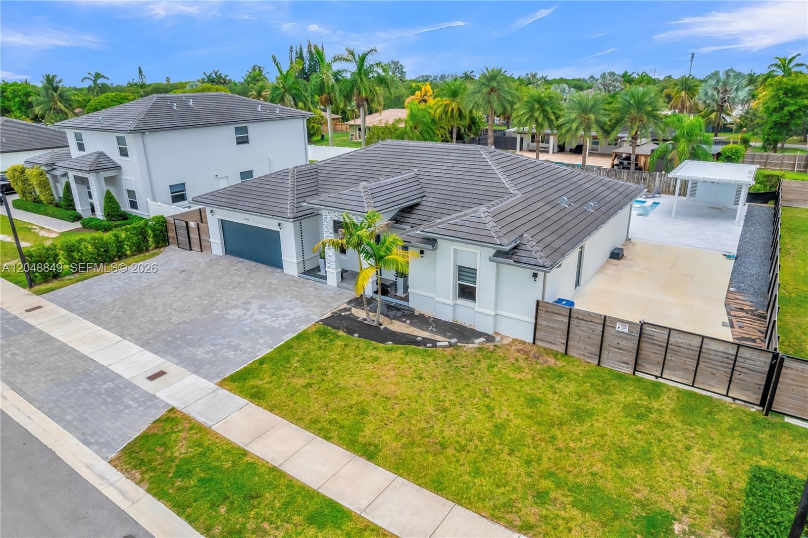 An aerial view shows a single-story house with a gray tile roof and driveway — 21100 SW 127th Pl, Miami FL 33177, MIAMI, FL