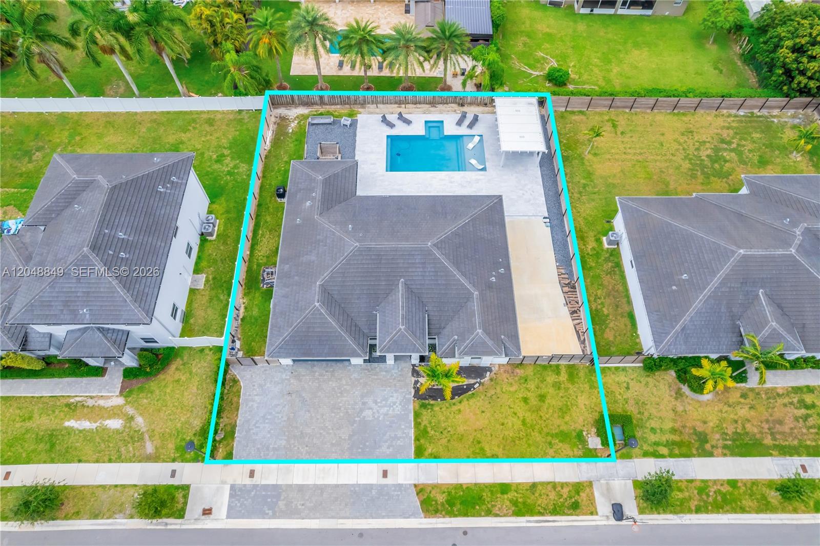 An aerial view shows a house with a tiled roof, a pool, and a fenced backyard — 21100 SW 127th Pl, Miami FL 33177, MIAMI, FL