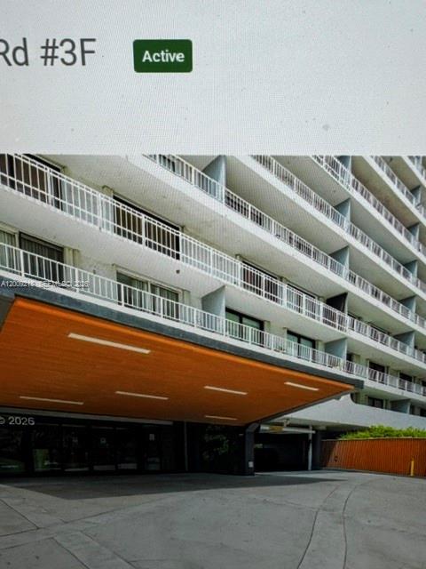 The exterior of a multi-story apartment building features a large orange canopy over the entrance — 200 SE 15th Rd, Miami FL 33129, MIAMI, FL