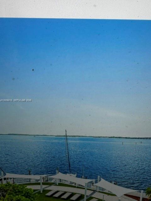 A view of a blue bay with a sailboat and white shade structures below — 200 SE 15th Rd, Miami FL 33129, MIAMI, FL