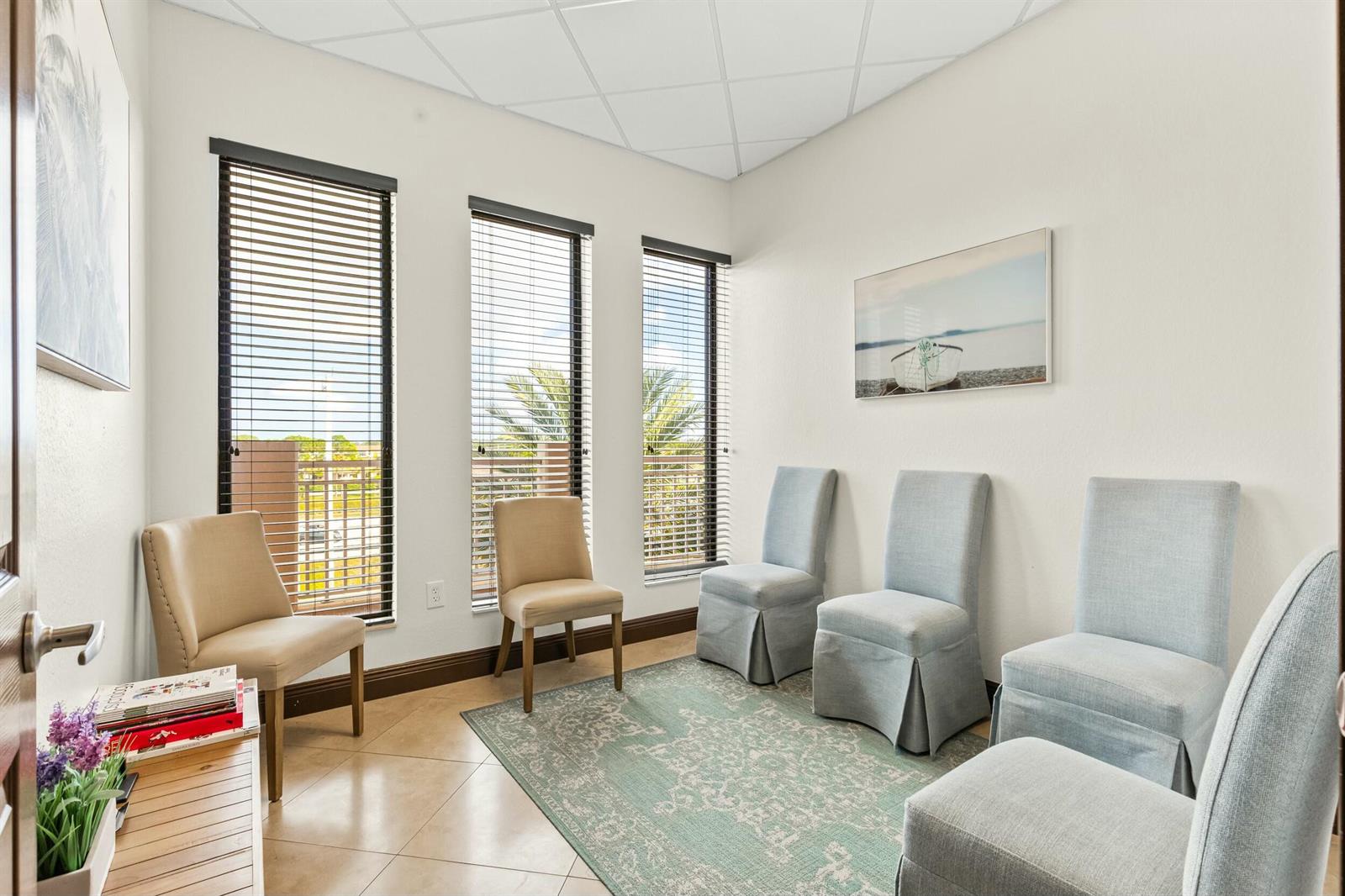 A waiting room with tile floors, a patterned rug, and several chairs near three windows — 3319 S State Rd 7, Wellington FL 33449, WELLINGTON, FL