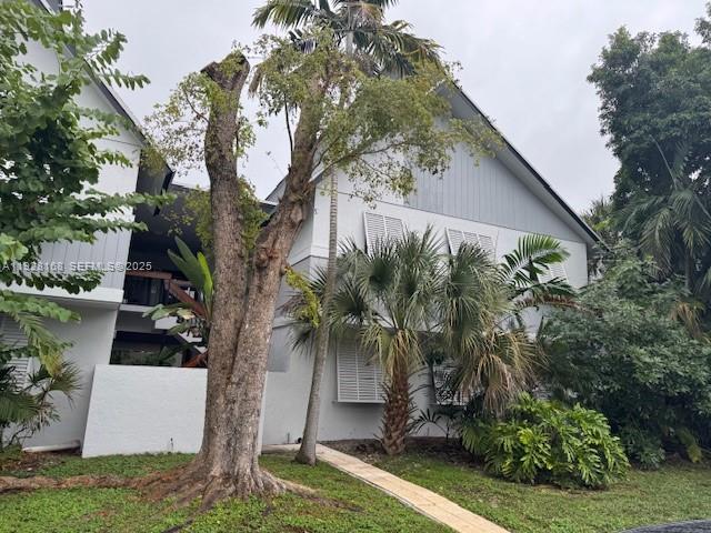 A multi-story white building with gray accents is surrounded by trees and lush landscaping — 7325 SW 63rd Ave # B, South Miami FL 33143, SOUTH MIAMI, FL