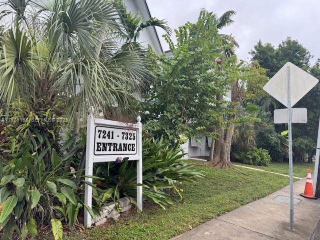 A white sign marking an entrance stands among lush green tropical plants and trees — 7325 SW 63rd Ave # B, South Miami FL 33143, SOUTH MIAMI, FL