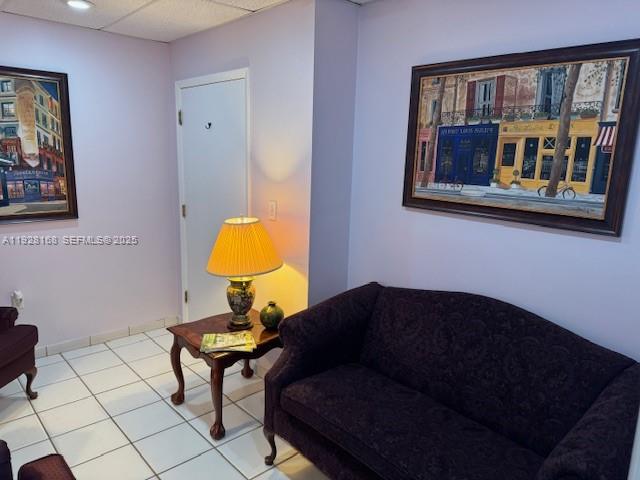 A room with a dark sofa, a side table with a lamp, and two framed paintings — 7325 SW 63rd Ave # B, South Miami FL 33143, SOUTH MIAMI, FL