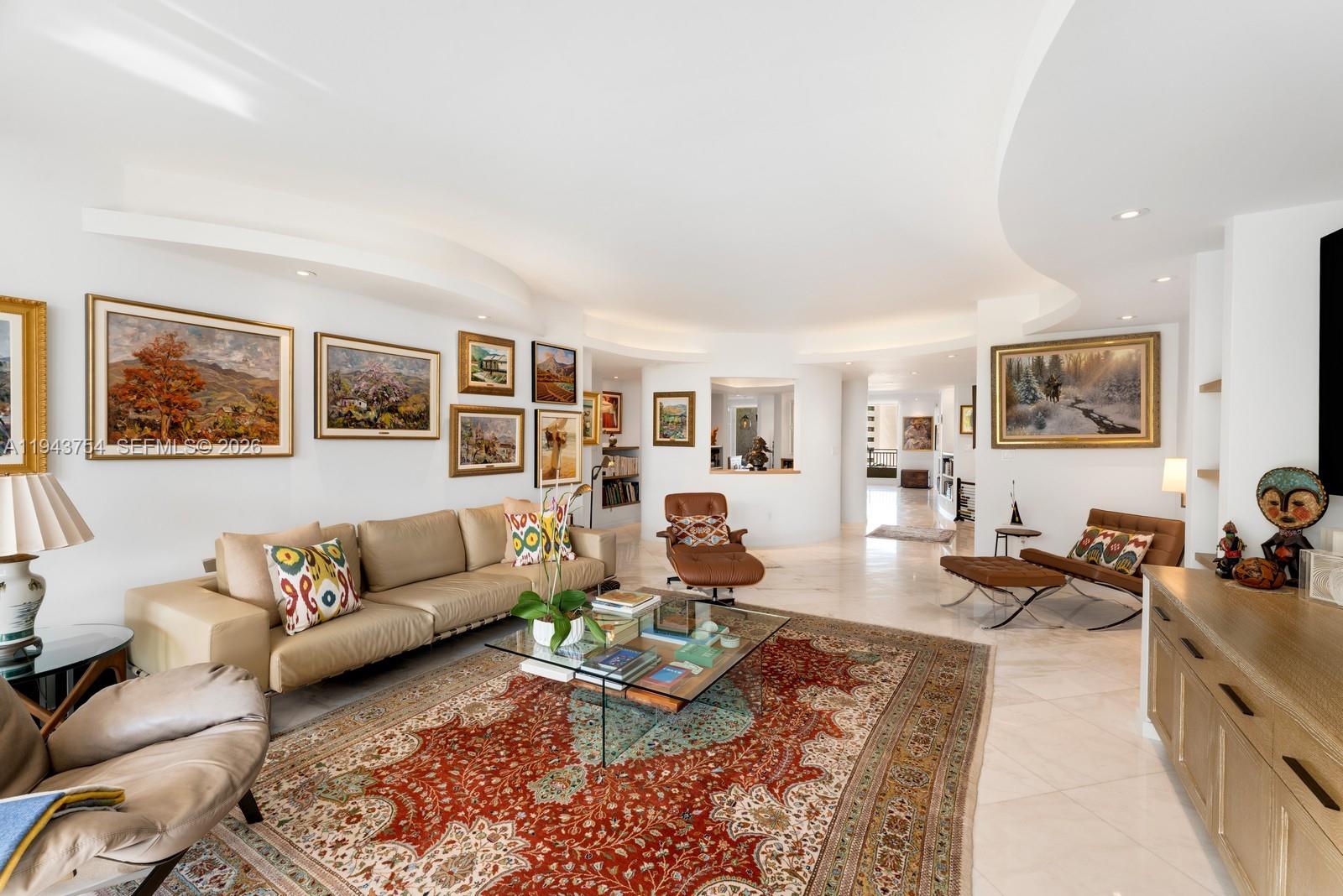 A spacious living room features a large patterned rug, leather seating, and multiple framed paintings — 791 Crandon Blvd # 603, Key Biscayne FL 33149, KEY BISCAYNE, FL
