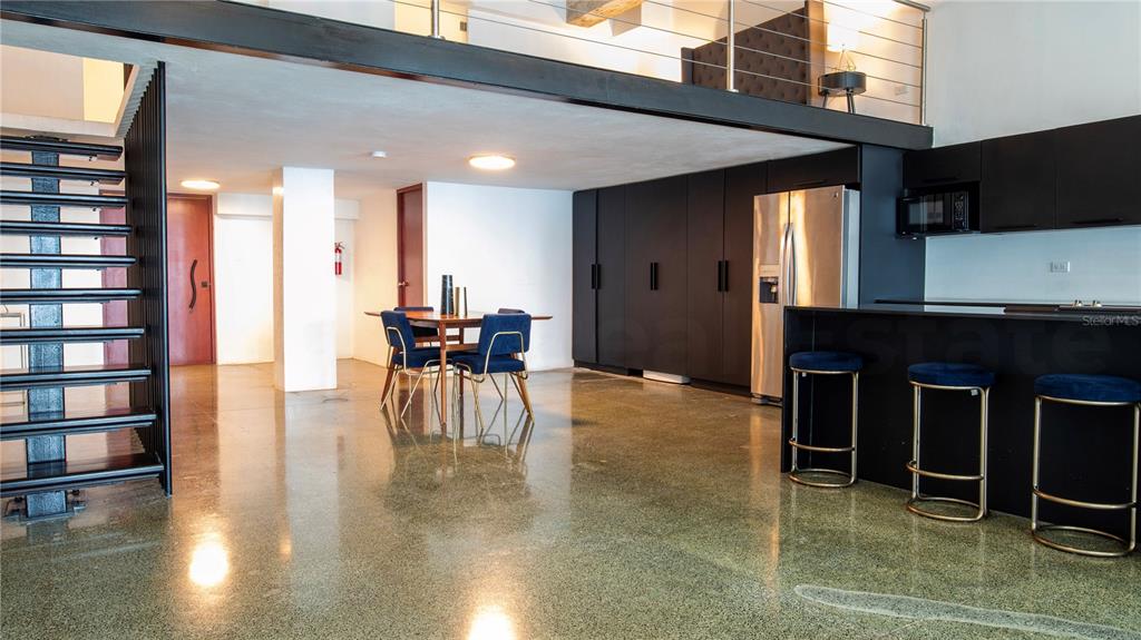 A modern open-concept living space features a kitchen, dining area, and a lofted bedroom level — 203 RECINTO SUR UNIT 5, OLD SAN JUAN, PR