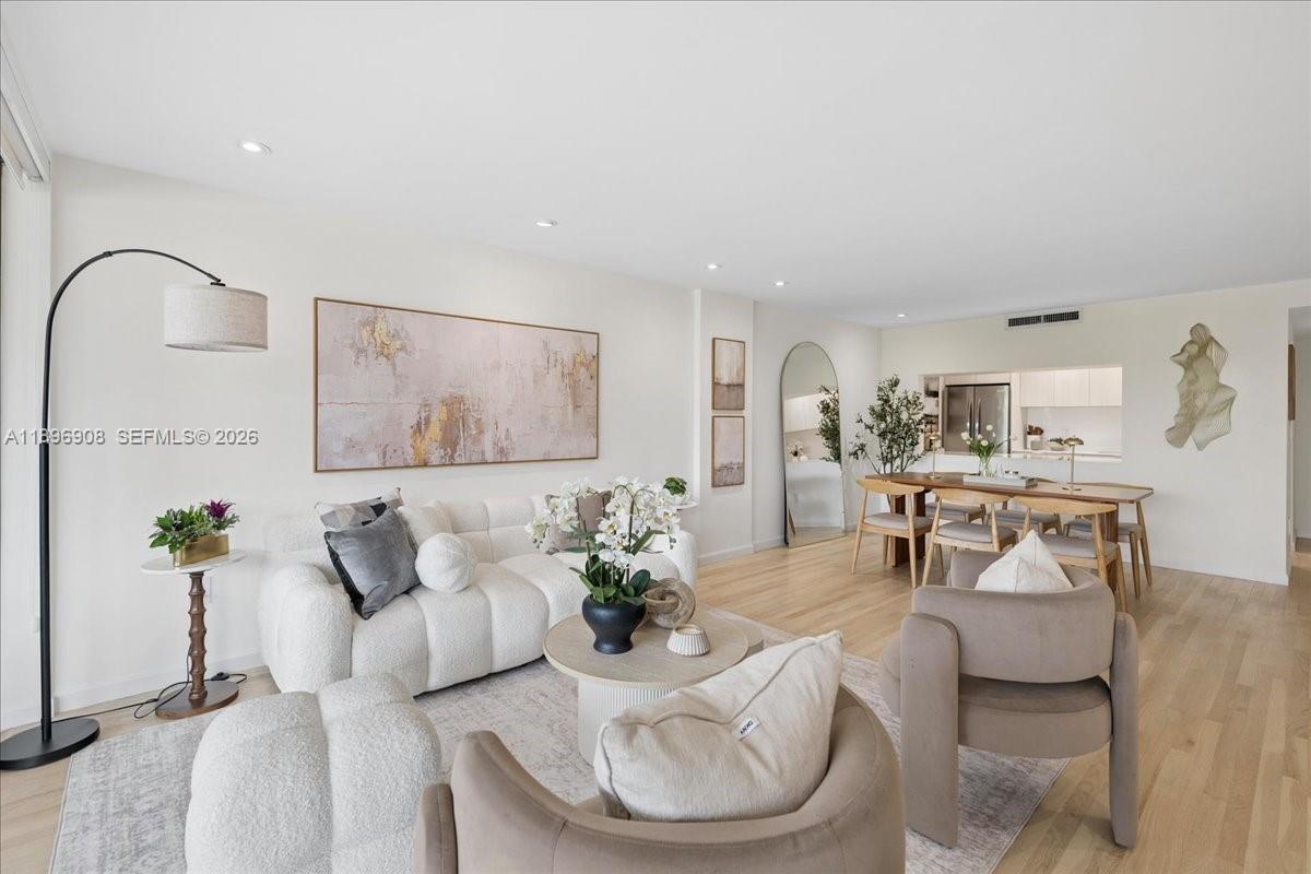 A bright living and dining area features light wood floors, neutral furniture, and modern decor — 155 Ocean Lane Dr # 302, Key Biscayne FL 33149, KEY BISCAYNE, FL