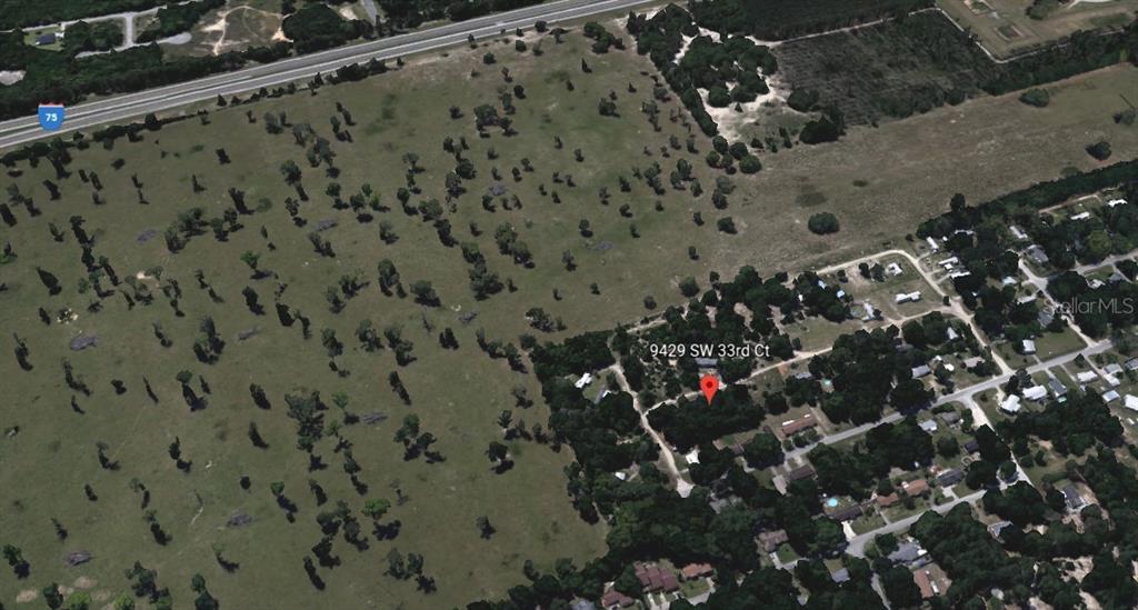 This aerial map view shows a residential property surrounded by trees and open fields — 9365 SW 32ND TERRACE, OCALA, FL