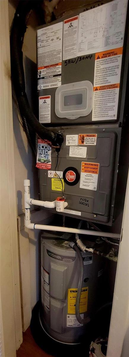 A utility closet contains a Rheem air handler unit stacked above an A.O. Smith water heater — 6260 S Falls Circle Drive # 206, Lauderhill FL 33319, LAUDERHILL, FL