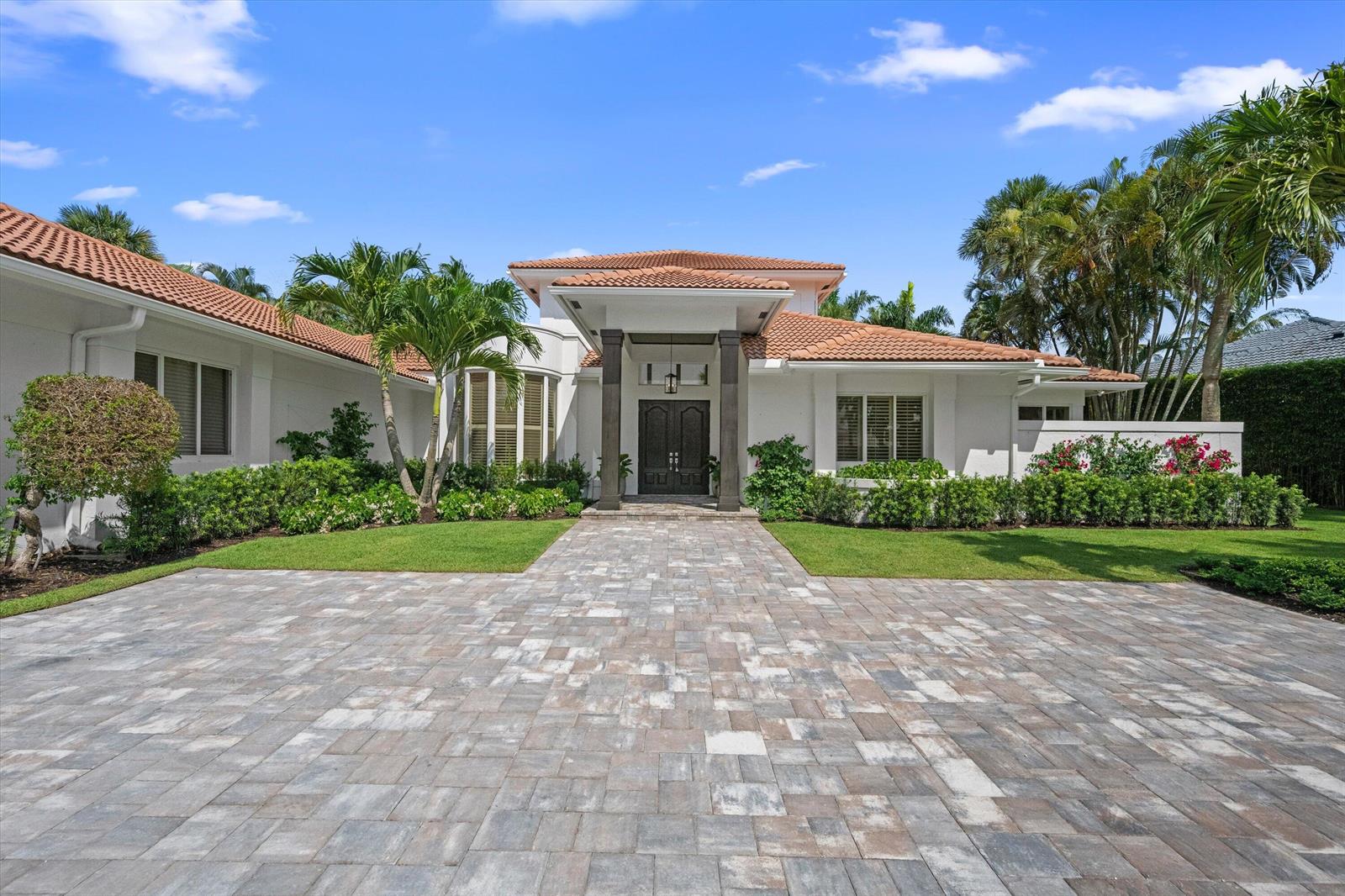 A single-story house with a tiled roof, white exterior, and a stone-paved driveway — 2432 Golf Brook Drive, Wellington FL 33414, WELLINGTON, FL