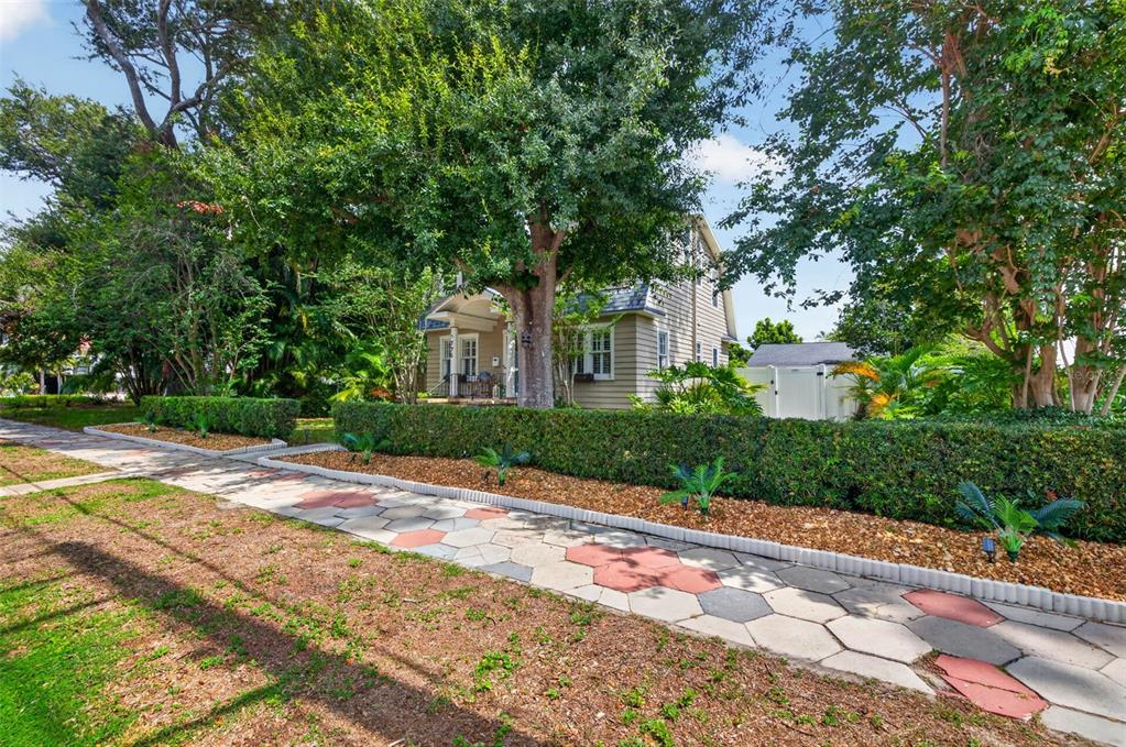 A living room features a white brick fireplace, a patterned rug, and two armchairs — 775 28TH AVENUE N, ST PETERSBURG, FL