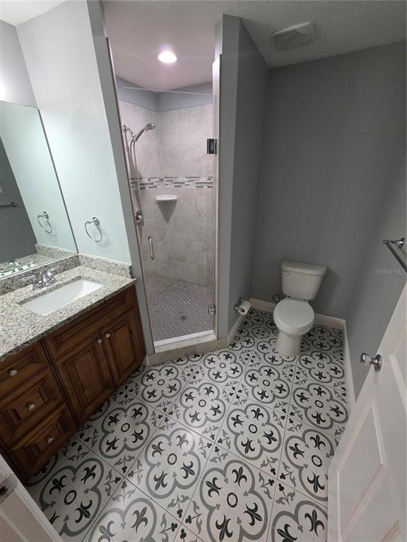 A living room features tile flooring, a large sectional sofa, and a television on a stand — 1607 E LINEBAUGH AVENUE, TAMPA, FL