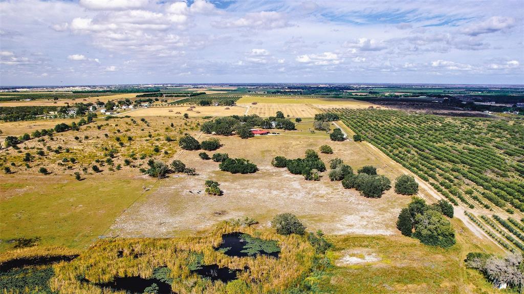 An aerial view shows a rural property with a house, pasture, and citrus groves — 0 EDWARDS ROAD UNIT 0, HAINES CITY, FL