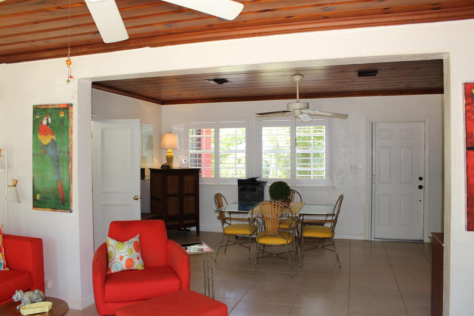 A living and dining area features a wood-paneled ceiling, white walls, and tile flooring — 225 Gulfstream Boulevard, Boynton Beach FL 33435, BOYNTON BEACH, FL