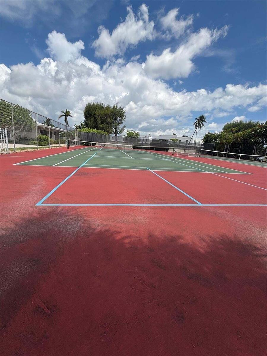 A red and green outdoor tennis court is surrounded by a chain-link fence — 1260 Sugar Sands Boulevard # 206, Singer Island FL 33404, SINGER ISLAND, FL