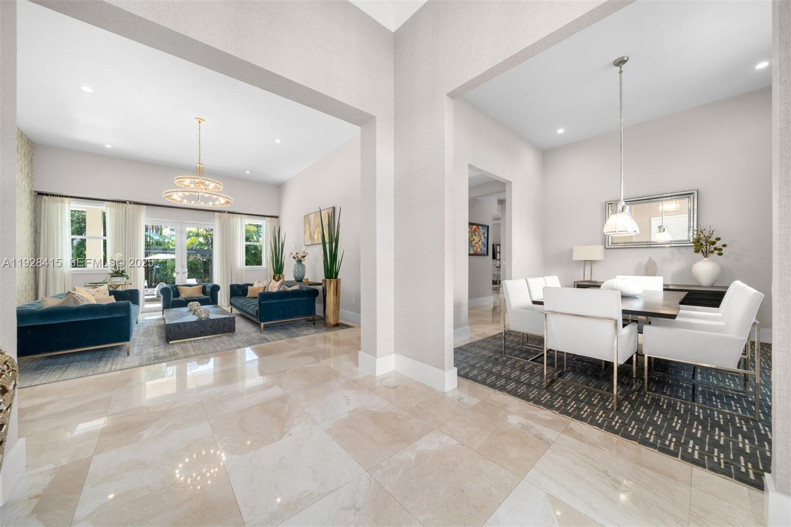 A bright, open-concept living and dining area features polished tile floors and modern furniture — 7222 SW 79th Ter, Miami FL 33143, MIAMI, FL