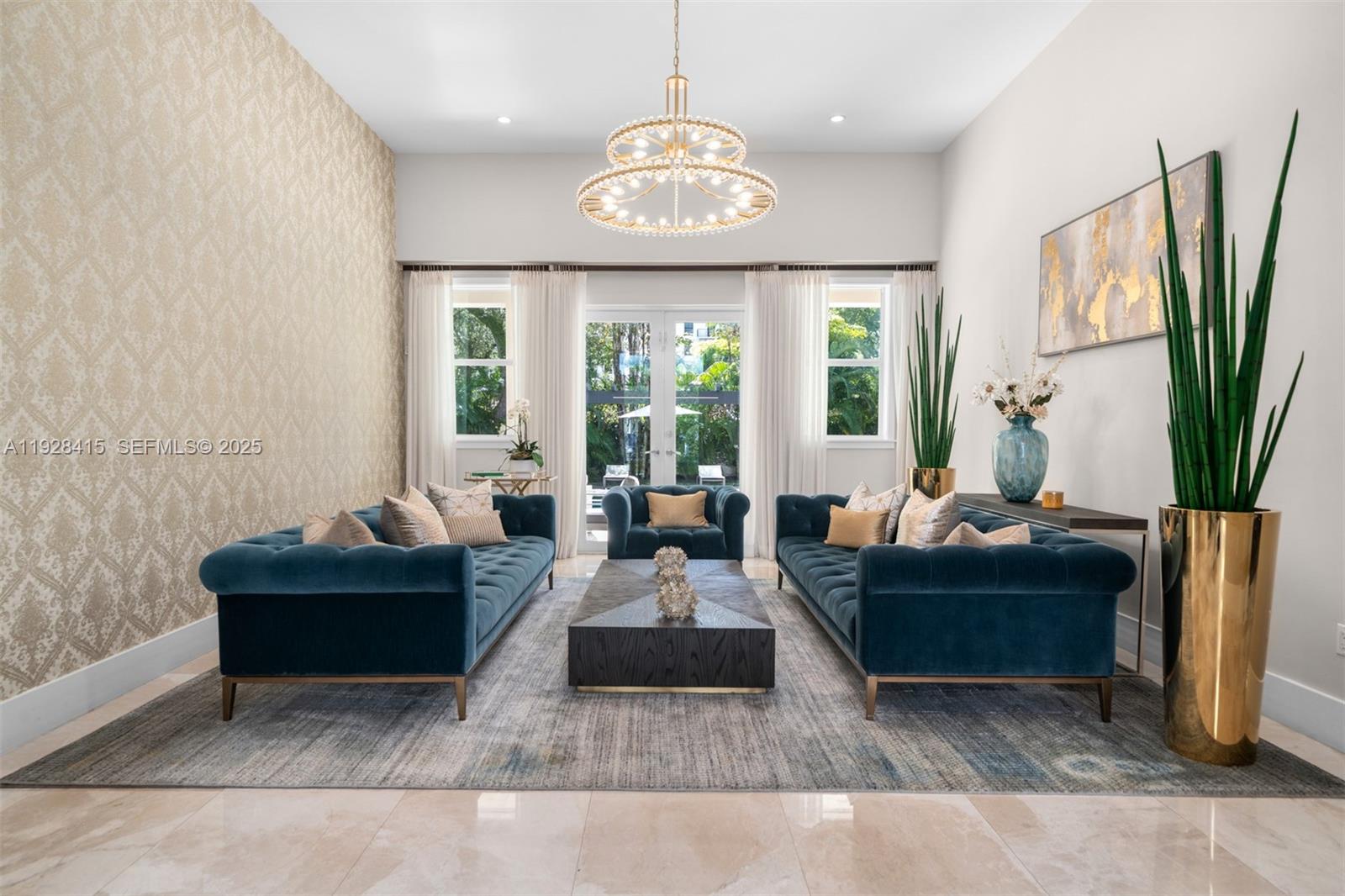 A formal living room features two blue velvet sofas, a central coffee table, and wallpaper — 7222 SW 79th Ter, Miami FL 33143, MIAMI, FL