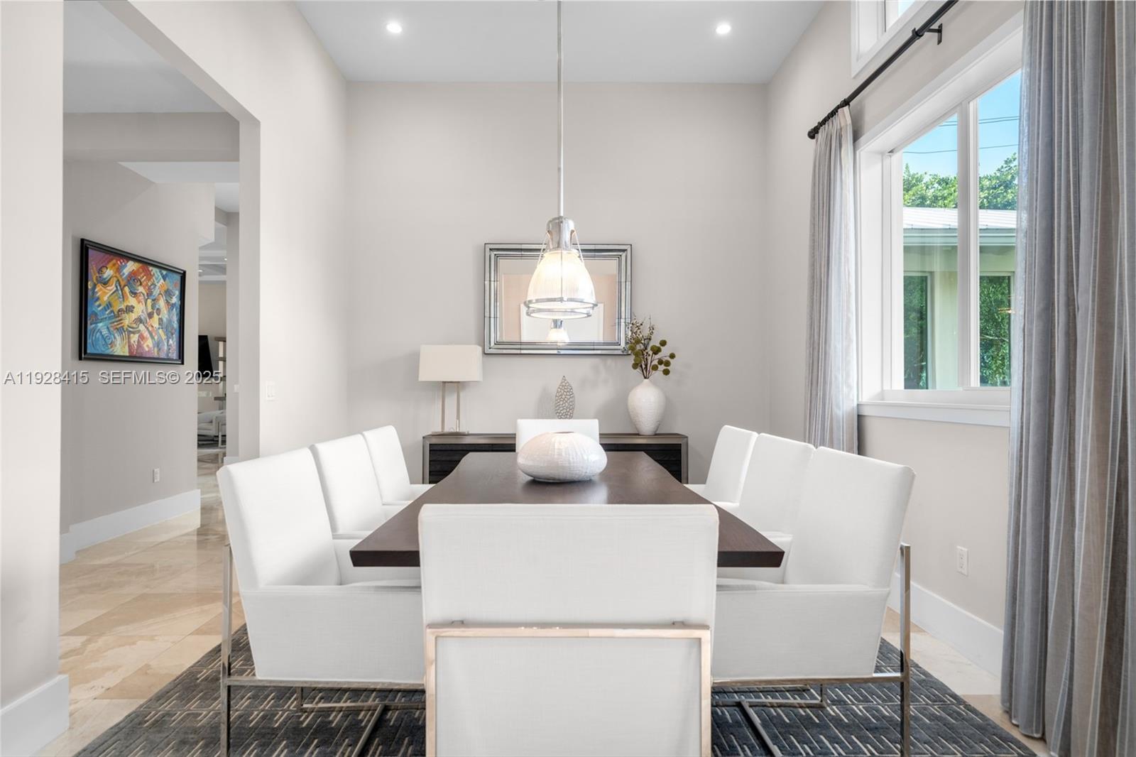 A dining room features a dark wood table, white upholstered chairs, and a pendant light — 7222 SW 79th Ter, Miami FL 33143, MIAMI, FL