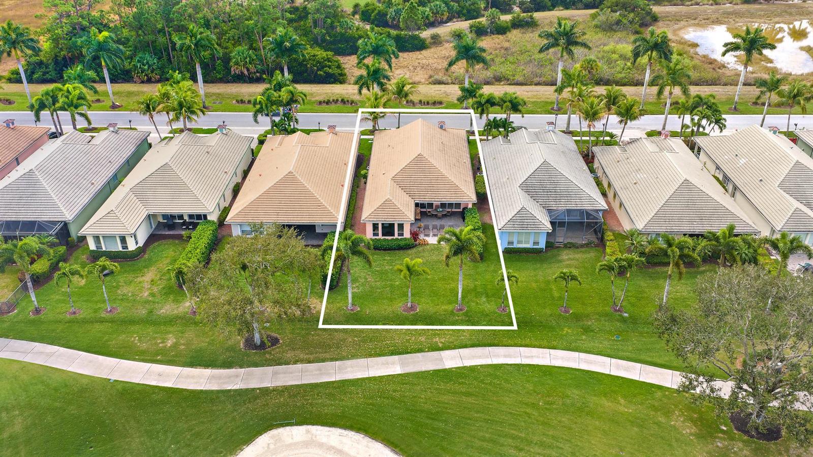 An aerial view shows a residential house with a tan roof and backyard palm trees — 10675 La Strada, West Palm Beach FL 33412, WEST PALM BEACH, FL