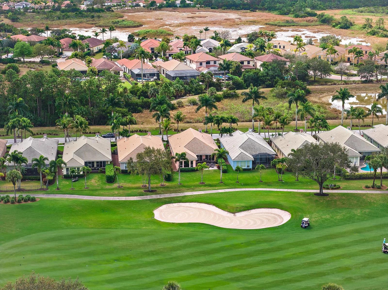 An aerial view of houses bordering a golf course with a sand bunker and cart — 10675 La Strada, West Palm Beach FL 33412, WEST PALM BEACH, FL