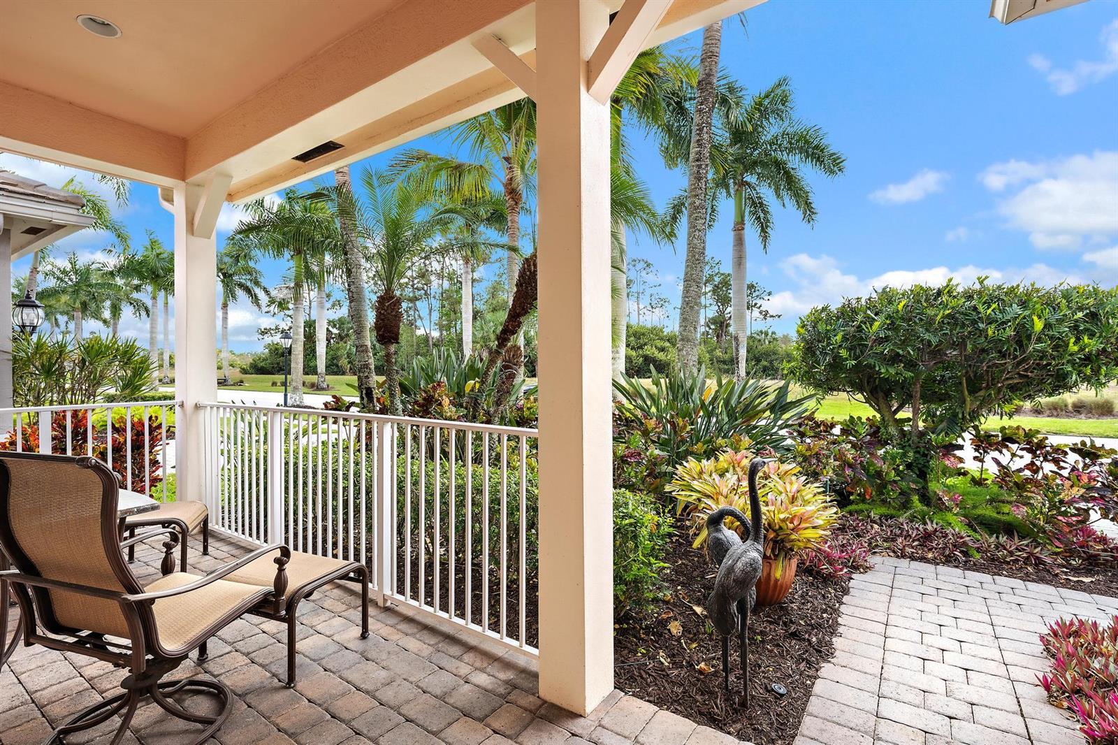 A covered patio with a white railing overlooks a landscaped yard with palm trees — 10675 La Strada, West Palm Beach FL 33412, WEST PALM BEACH, FL