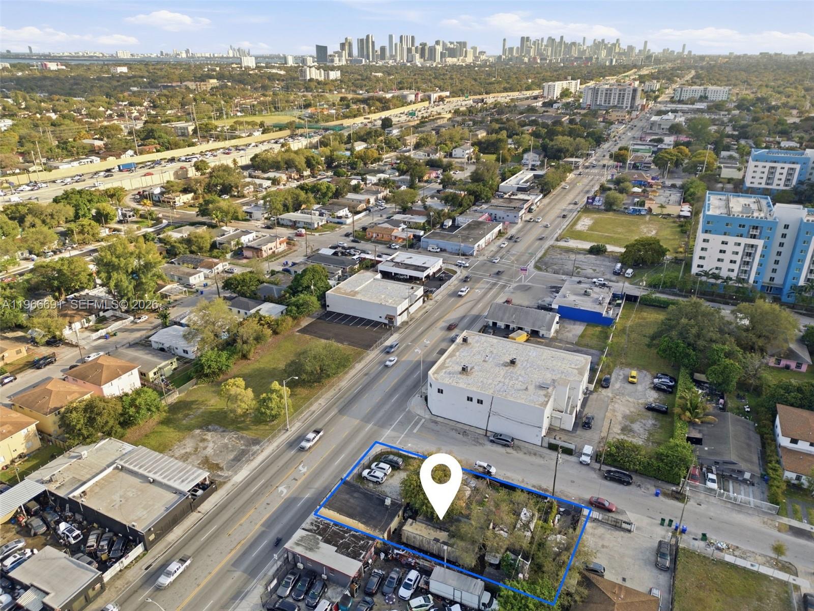 An aerial view shows a fenced, rectangular lot with a small building and parked cars — 7010 NW 7th Ave, Miami FL 33150, MIAMI, FL