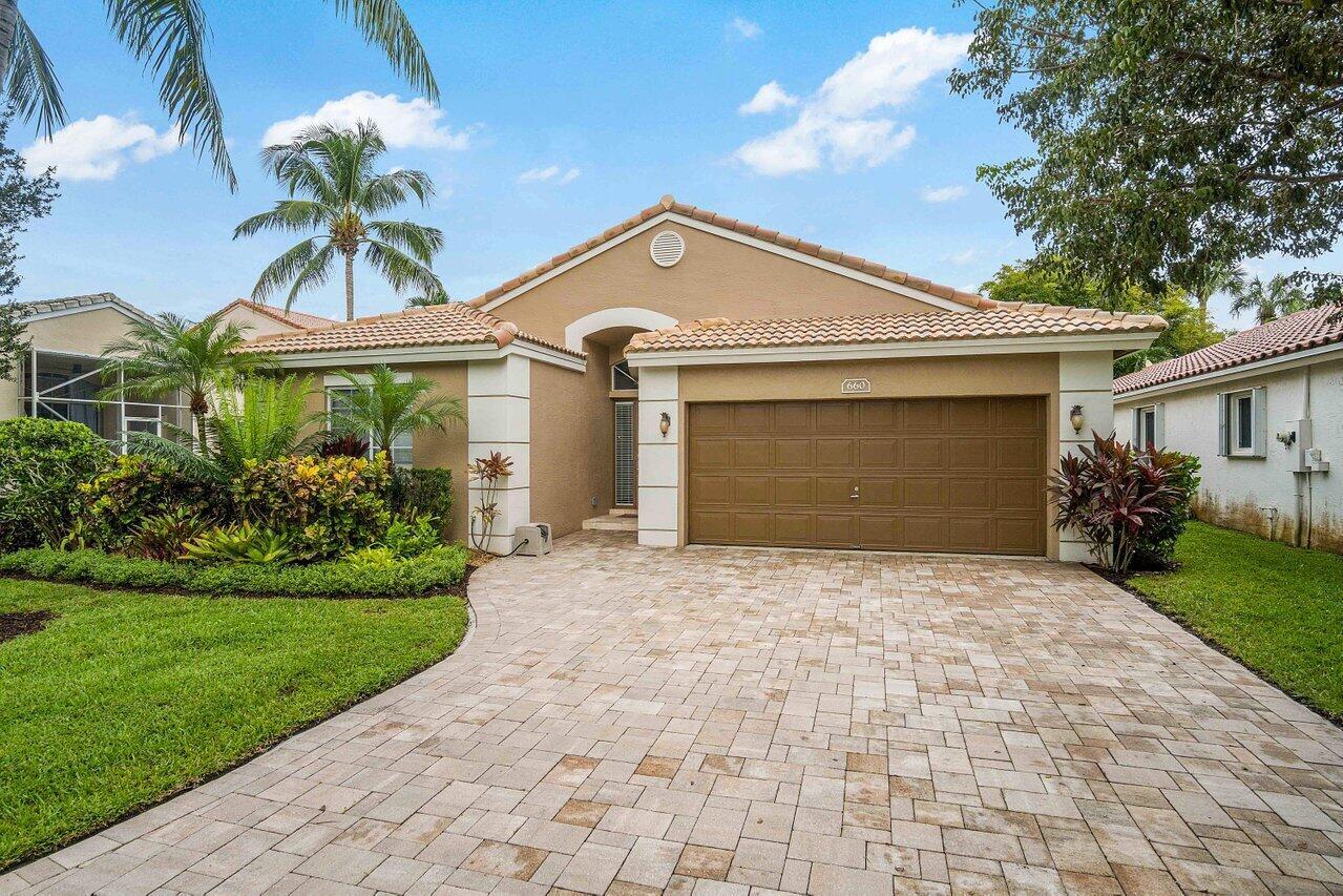 A single-story house with a tan stucco exterior, a tiled roof, and a paved driveway — 660 NW 45th Avenue, Deerfield Beach FL 33442, DEERFIELD BEACH, FL