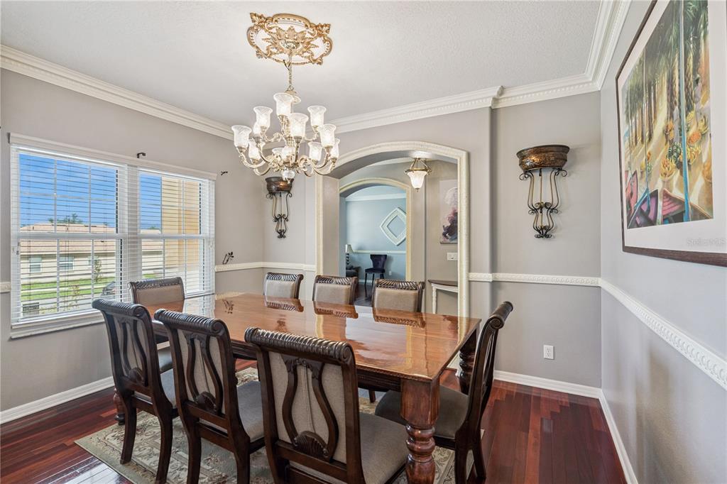 A living room with a large brown sectional sofa opens to a kitchen and dining area — 480 ROB ROY DRIVE, CLERMONT, FL