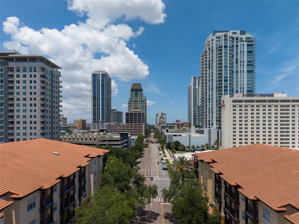 An elevated view of a city street lined with tall apartment buildings and palm trees — 200 4TH AVENUE S UNIT 110, ST PETERSBURG, FL