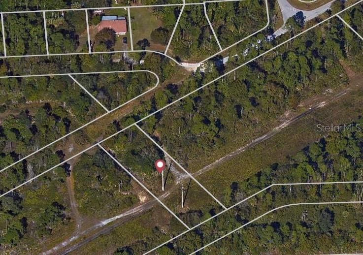 An aerial map view shows a vacant, wooded lot marked with a red location pin — 26430 PEACHLAND LANE, PUNTA GORDA, FL