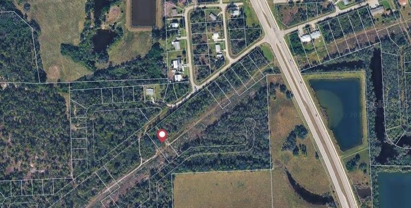 An aerial map view shows a wooded lot marked with a red pin — 26430 PEACHLAND LANE, PUNTA GORDA, FL